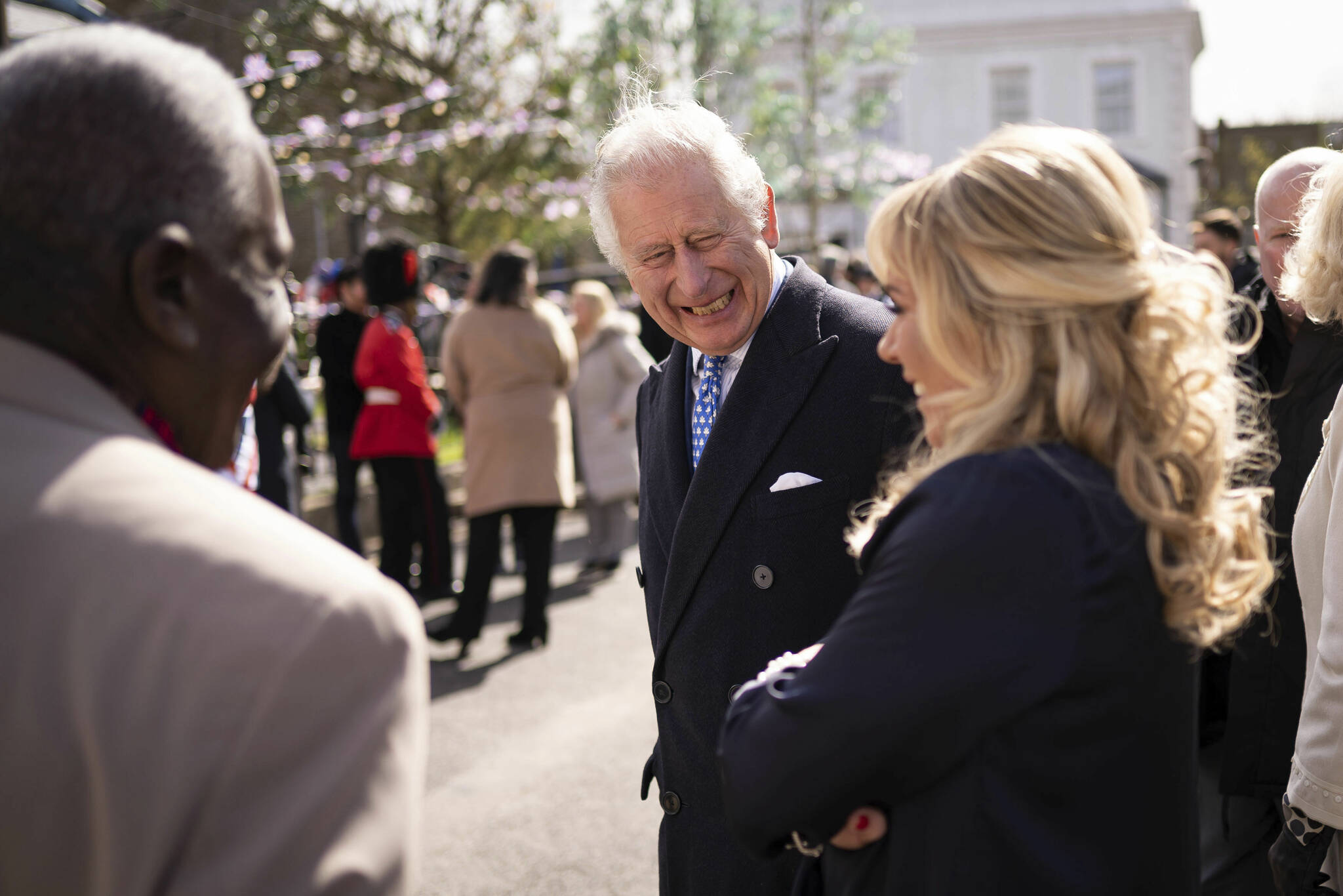 Britain’s Prince Charles, centre, reacts with Letitia Dean, as he and Camilla, the Duchess of Cornwall visit the set of EastEnders at the BBC studios in Elstree, Hertfordshire, England, Thursday March 31, 2022. (Aaron Chown/Pool Photo via AP)