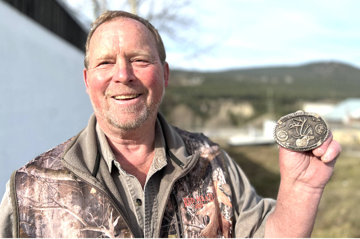 Dan Simmons shows off an award he received from the Guide Outfitters Association of B.C. for his efforts to conserve cow moose. (Angie Mindus photo - Williams Lake Tribune)