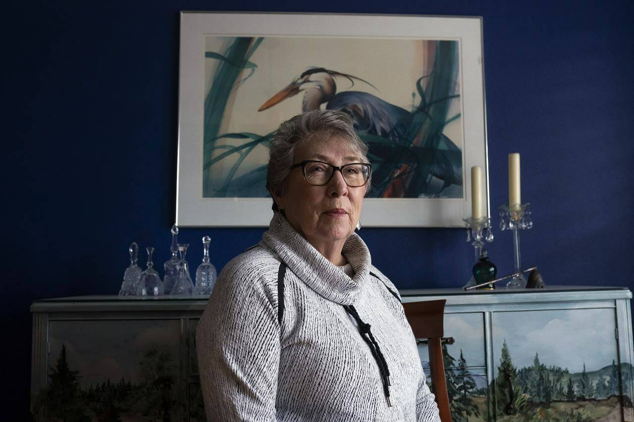 Joyce Ares sits for a portrait in the dinning room of her home on Friday, March 18, 2022, in Canby, Ore. When she turned 74, Ares was feeling fine when she agreed to give a blood sample for research. So she was surprised when the screening test came back positive for signs of cancer. After a repeat blood test, a PET scan and a needle biopsy, she was diagnosed with Hodgkin lymphoma. (AP Photo/Nathan Howard)