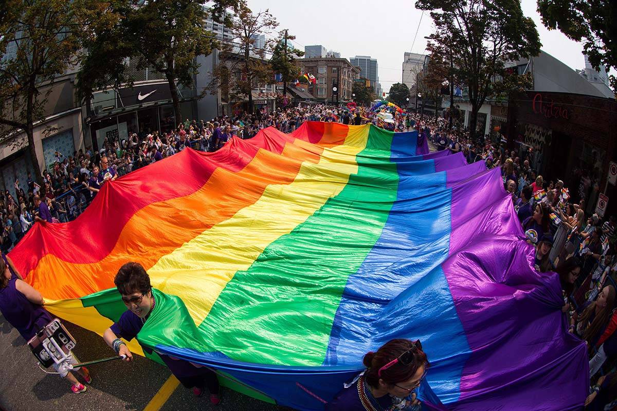 A giant rainbow flag is carried on Robson Street during the Vancouver Pride Parade in 2017. A new report out of UBC suggests the lives and health of LGBTQ youth in B.C. are improving. (THE CANADIAN PRESS/Darryl Dyck)