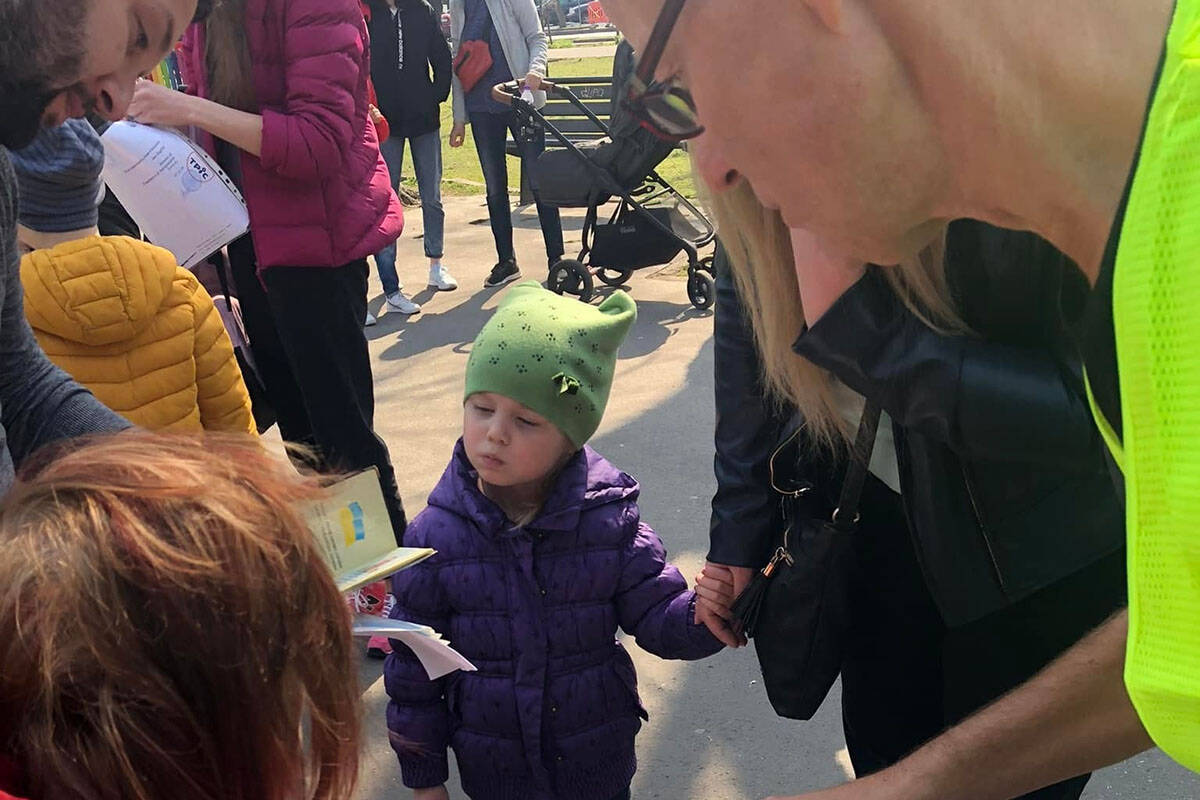A young Ukrainian child watches as helpers with Hope for the Nation in Romania hand out grocery cards to families who fled the war in Ukraine. (Facebook/ Hope for the Nation)