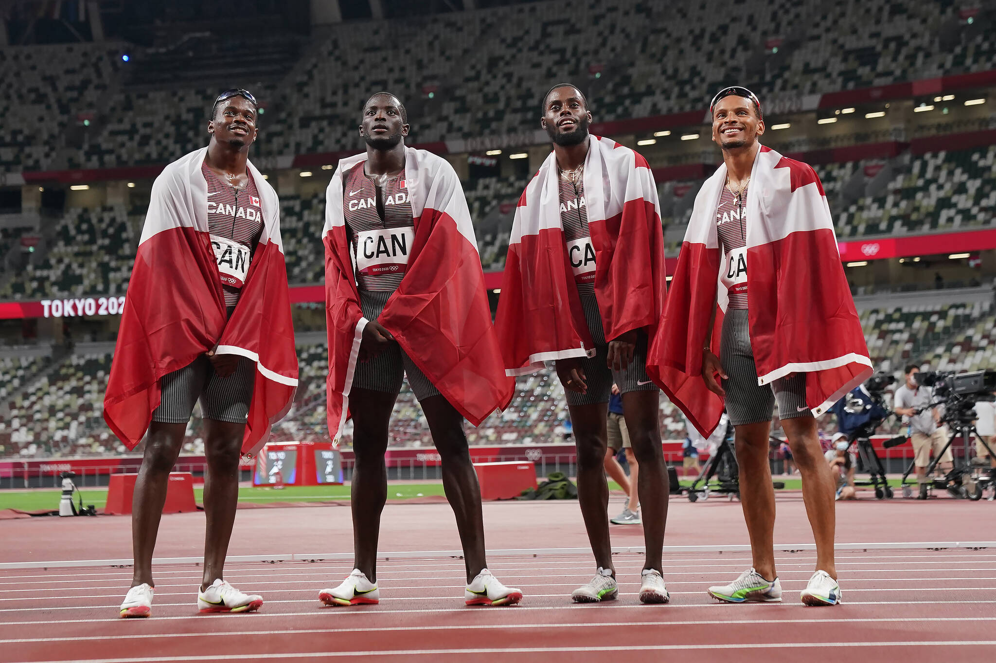 Memebrs of Canada’s 4 X100-metre relay team celebrate their bronze medal win during the Tokyo Olympics in Tokyo, Japan on Friday, Aug.6, 2021. THE CANADIAN PRESS/Nathan Denette