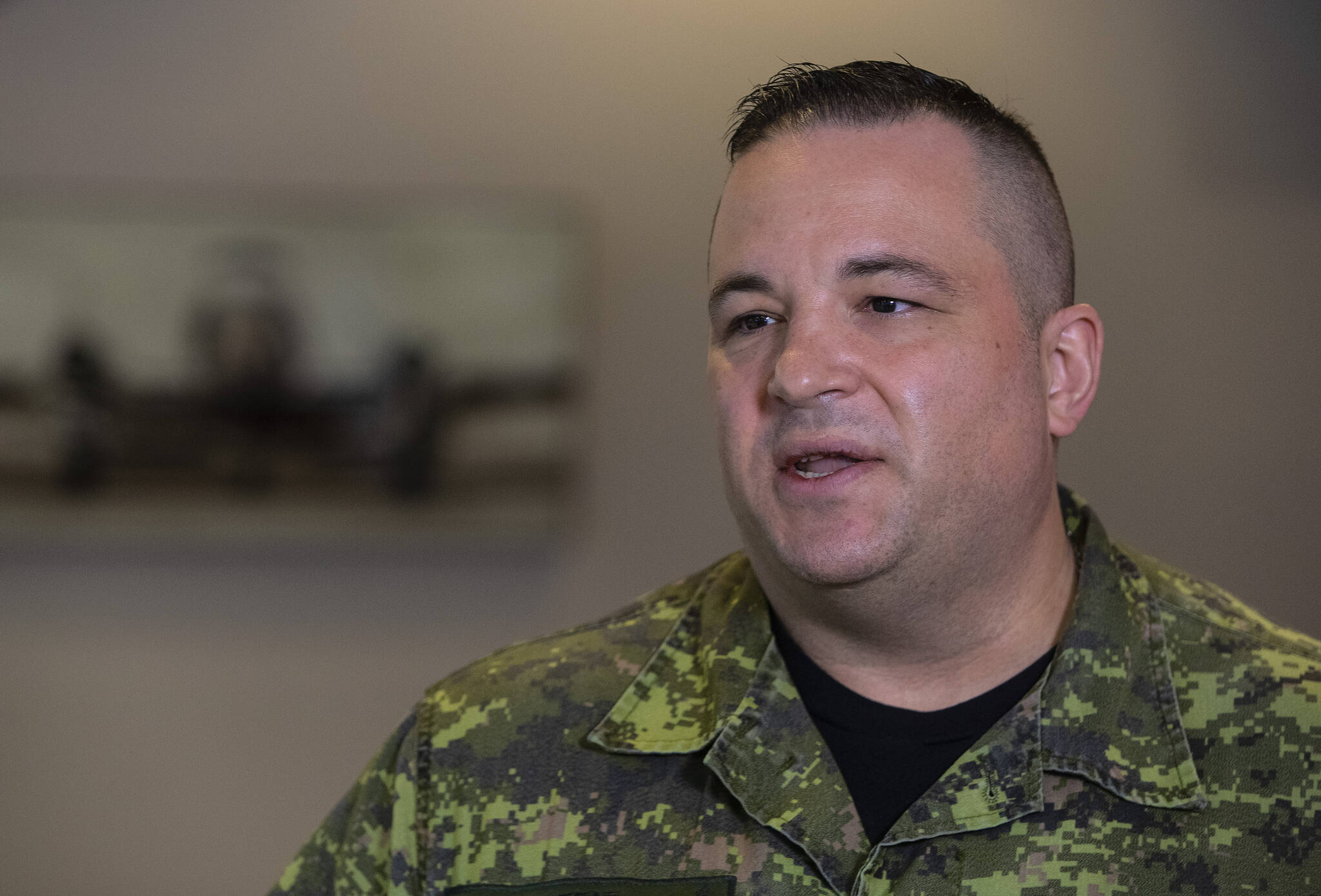 Lieutenant Kevin Moffat speaks with media before 80 soldiers from across 3rd Canadian Division deploy to Poland in order to join the lead elements already in that country as part of the Government of Canada’s response to the war in Ukraine, in Edmonton, Friday April 15, 2022. THE CANADIAN PRESS/Jason Franson