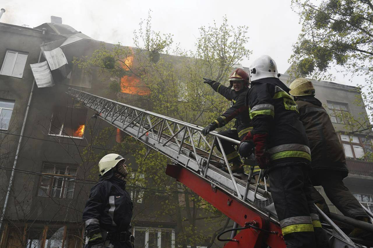 Firefighters work to extinguish fire at an apartments building after a Russian attack in Kharkiv, Ukraine, Sunday, April 17, 2022. (AP Photo/Andrew Marienko)