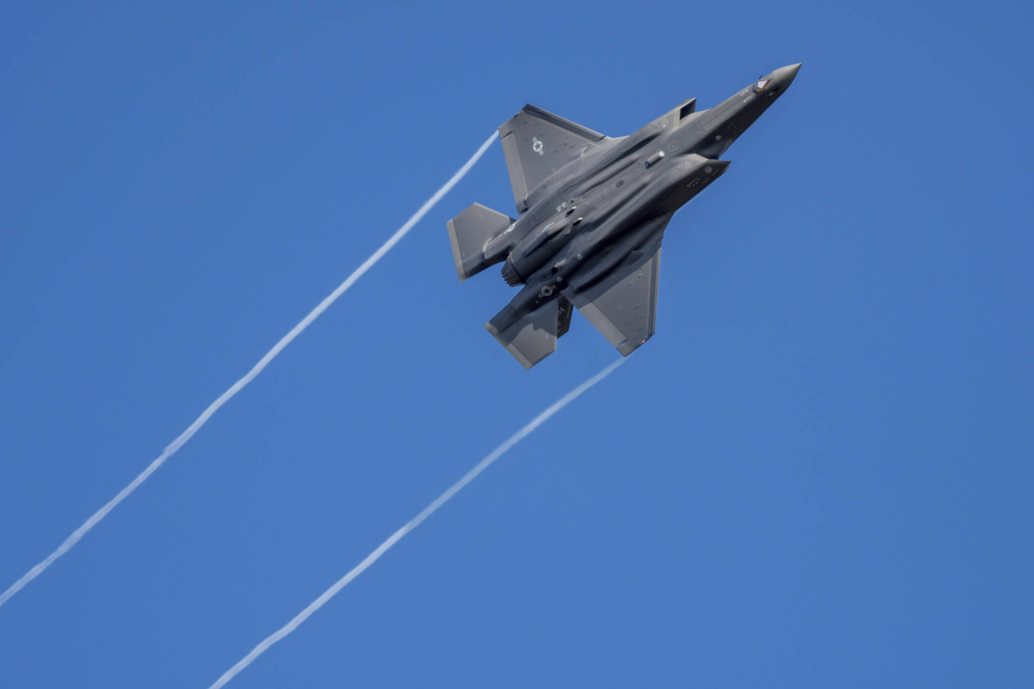 A U.S. F-35 fighter jet flies over the Eifel Mountains near Spangdahlem, Germany, Wednesday, Feb. 23, 2022. The U.S. Armed Forces moved stealth fighter jets to Spangdahlem Air Base a few days ago. The aircraft, built by the U.S. company Lockheed-Martin, is considered the most modern stealth fighter aircraft in the world. (Harald Tittel/dpa via AP)