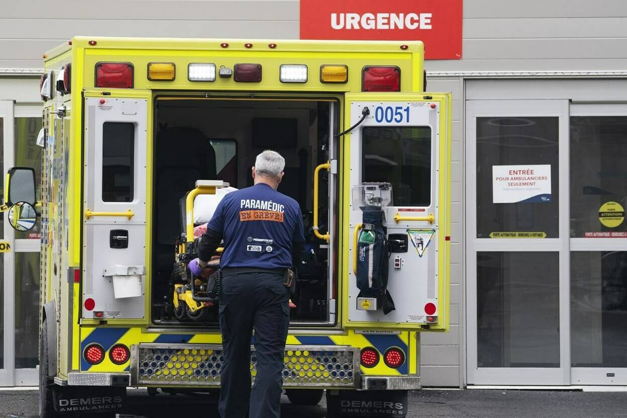 A paramedic loads a stretcher back into the ambulance after bringing a patient to the emergency room at a hospital in Montreal on Thursday, April 14, 2022. Hospitals across Canada are facing a resurgence of COVID-19 patients that some health officials say will continue for another month. THE CANADIAN PRESS/Ryan Remiorz