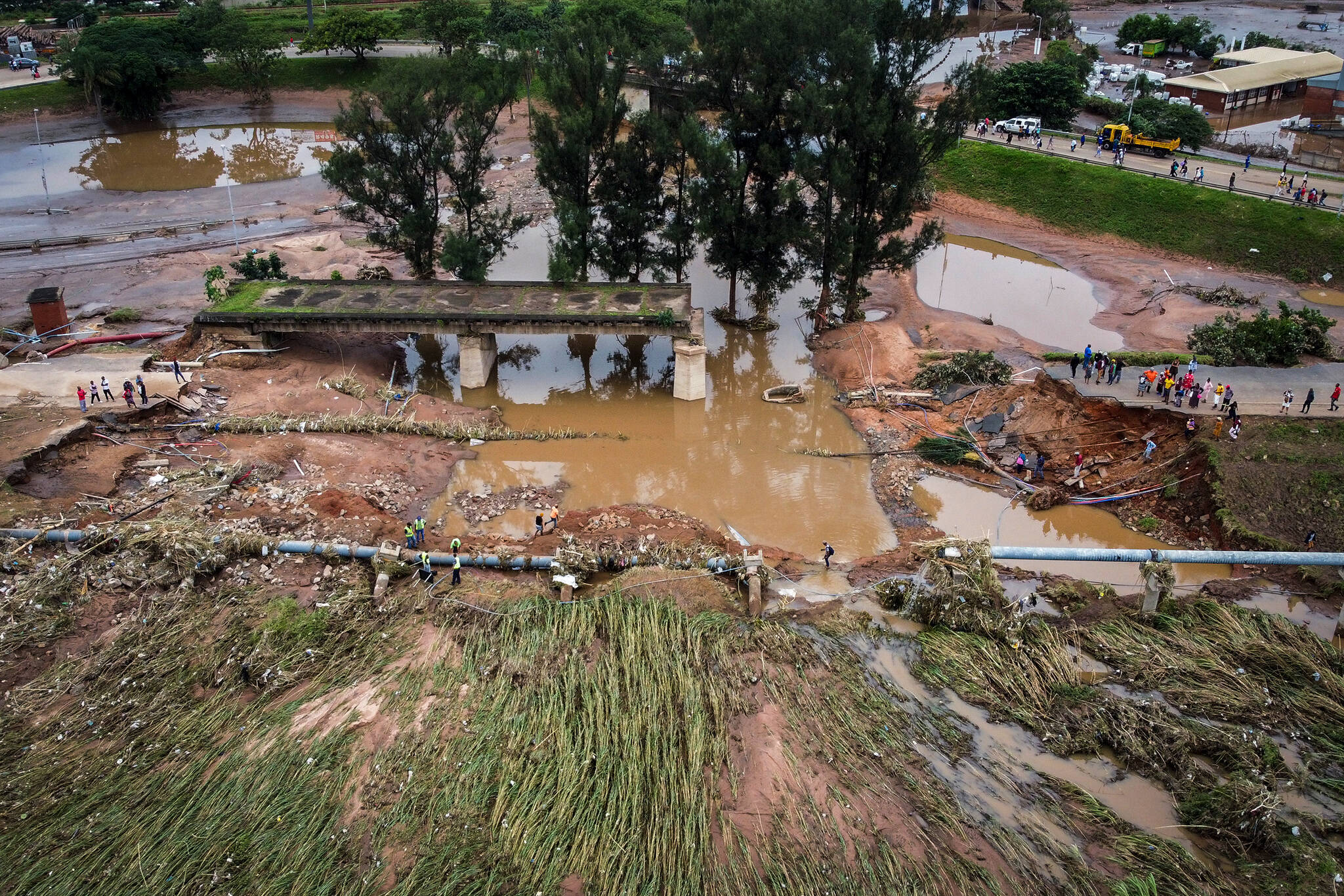 A collapsed bridge on the Griffiths Mxenge Highway after flooding in Durban, South Africa, Wednesday, April 13, 2022. Devastating floods in South Africa this week, as well as other extreme weather events across the continent linked to human-caused climate change, are putting marine and terrestrial wildlife species at risk, according to biodiversity experts. (AP Photo/Shiraaz Mohamed, File)