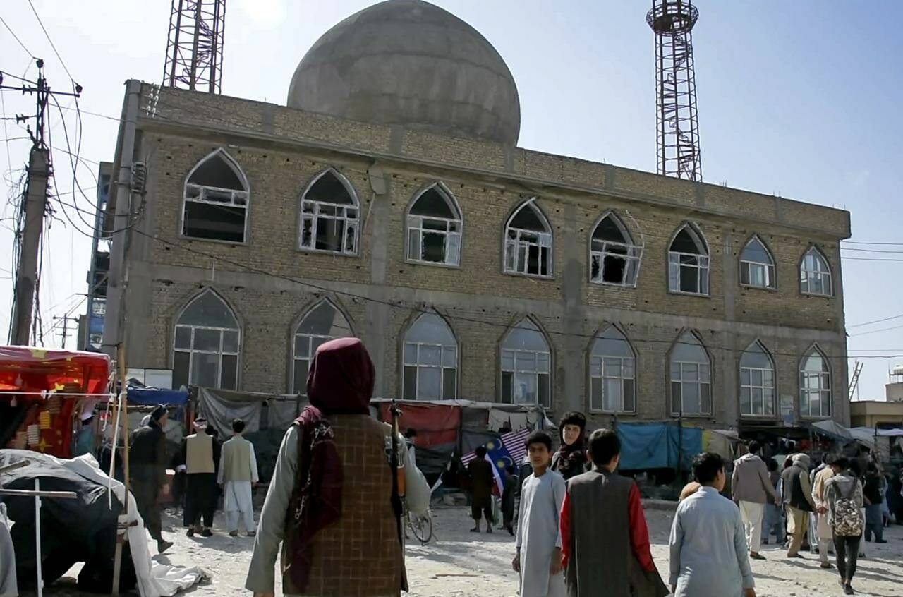 This frame grab image from video, shows a Taliban fighter standing guard outside the site of a bomb explosion inside a mosque, in Mazar-e-Sharif province, Afghanistan, Thursday, April 21, 2022. A series of explosions across Afghanistan on Thursday killed at least 10 people and wounded scores more, according to police and hospital officials. No one immediately took responsibility for the deadly explosions, but they mostly targeted the country’s minority Shiite Muslims and had all the hallmarks of a deadly Islamic State affiliate known as Islamic State in Khorasan Province, or IS-K. (AP Photo)