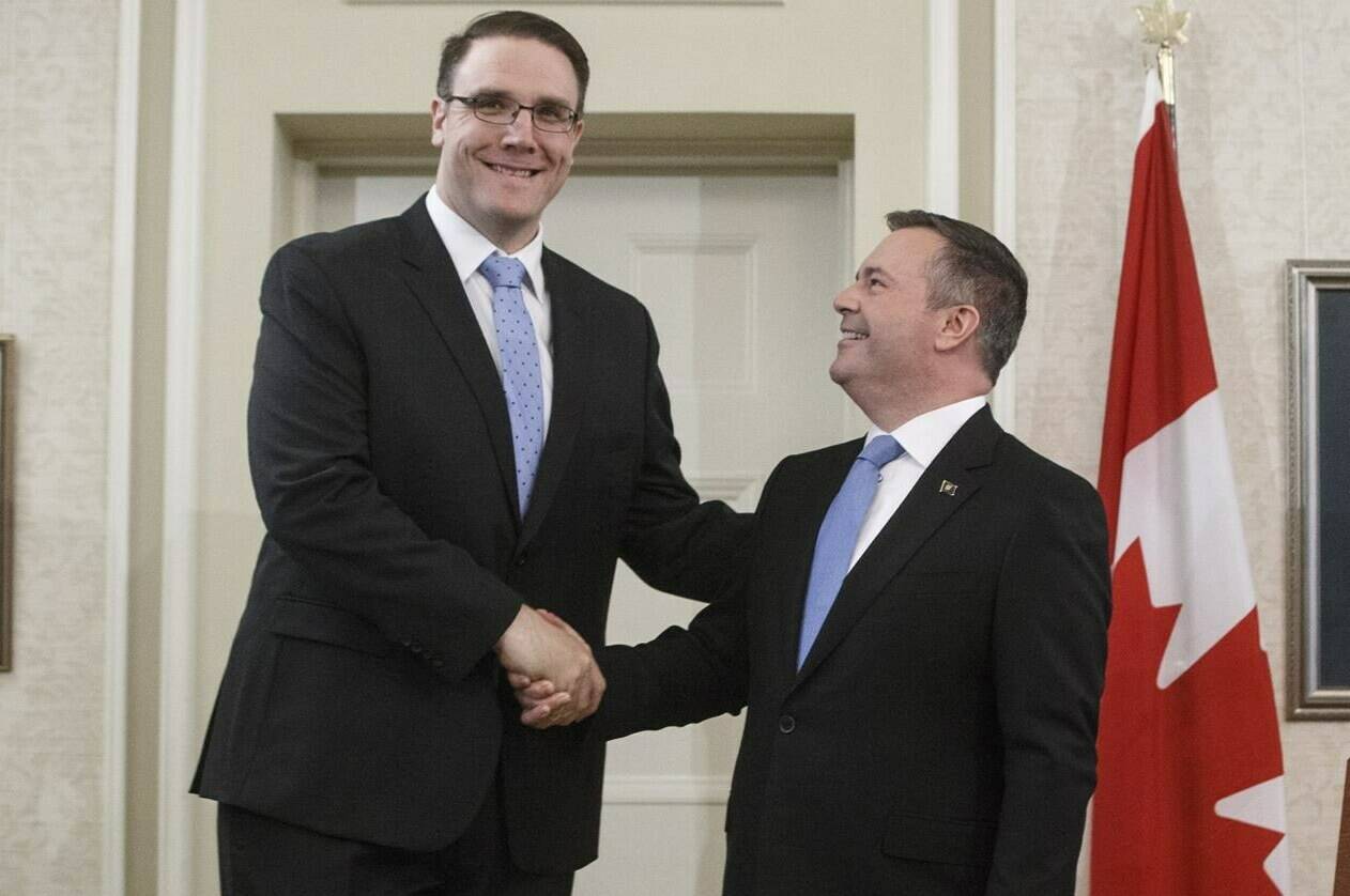 Alberta Premier Jason Kenney shakes hands with Jason Nixon in Edmonton on Tuesday, April 30, 2019. Nixon, Alberta government house leader, is facing accusations of intimidation following a fiery exchange in the house. THE CANADIAN PRESS/Jason Franson