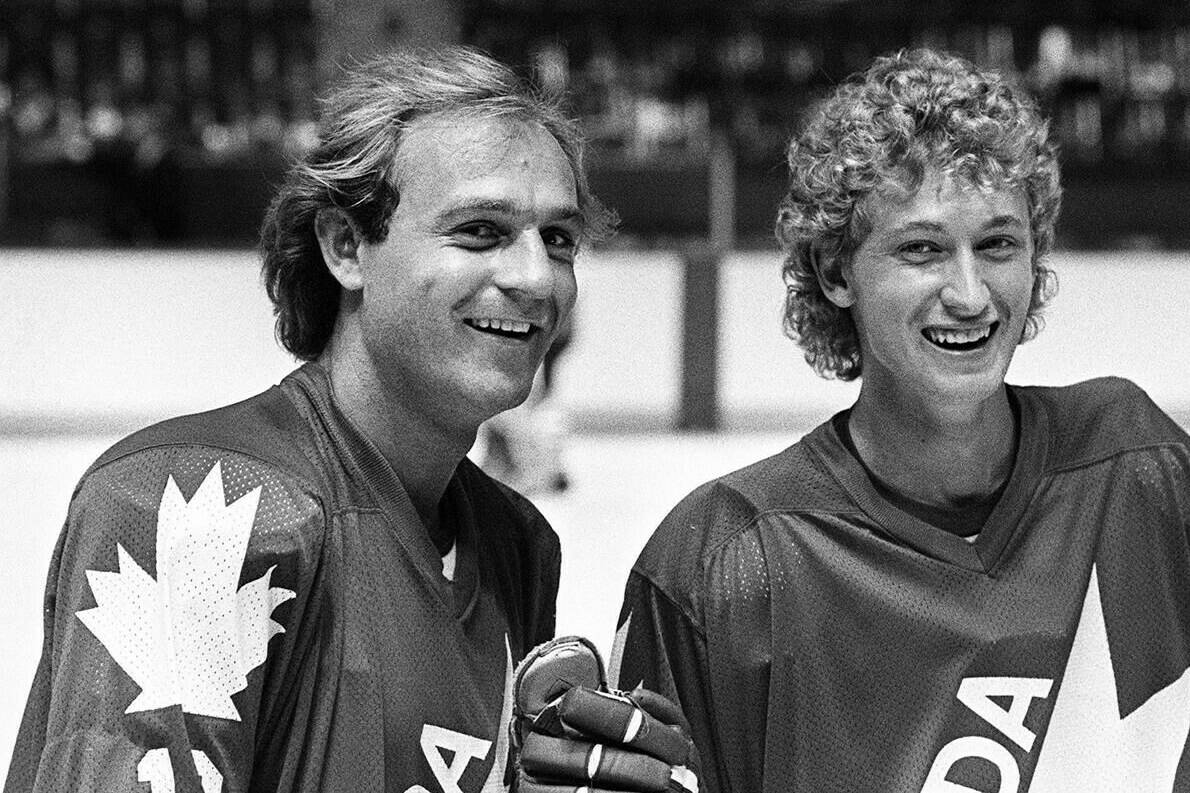 Montreal Canadien Guy Lafleur (left) and Wayne Gretzky of the Edmonton Oilers are seen here during a break in their light skate at the first day of training camp for Team Canada in Montreal, Aug. 10, 1981. (CP PHOTO/Ian MacAlpine)