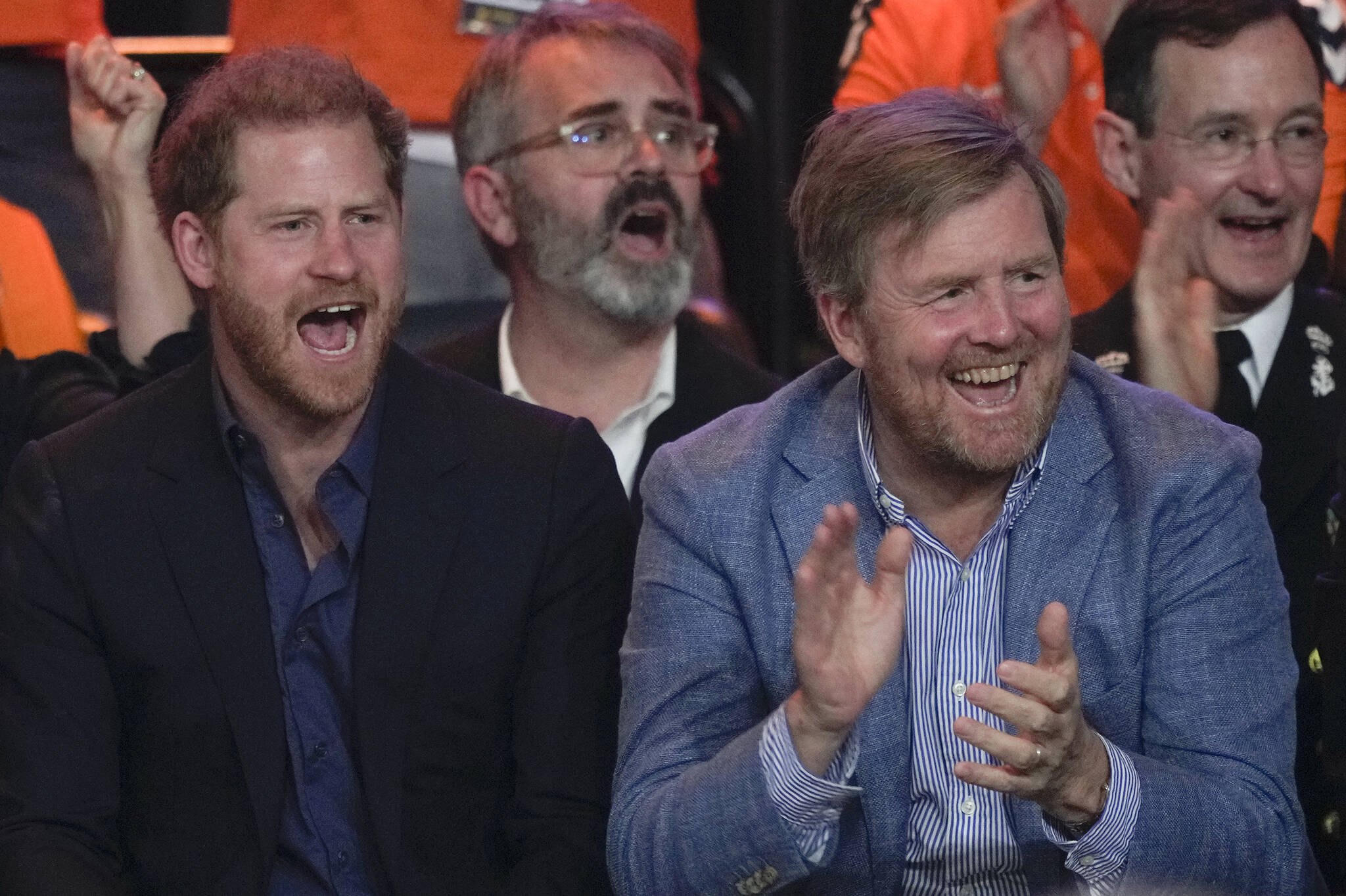 Prince Harry, Duke of Sussex, and Dutch King Willem-Alexander, cheered on competitors of the Wheelchair Basketball final between The Netherlands and the U.S. at the Invictus Games in The Hague, Netherlands, Friday, April 22, 2022. The week-long games for active servicemen and veterans who are ill, injured or wounded opened last Saturday in this Dutch city that calls itself the global center of peace and justice. (AP Photo/Peter Dejong)