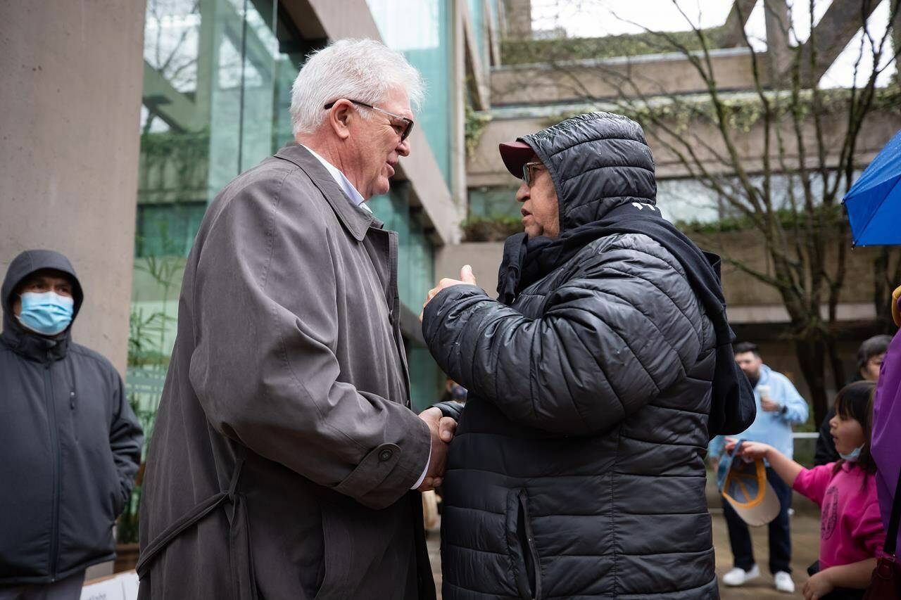 Nuchatlaht First Nation elder and councillor Archie Little, right, speaks with lawyer Jack Woodward outside B.C. Supreme Court before the start of an Indigenous land title case, in Vancouver, on Monday, March 21, 2022. The lawyer for a B.C. First Nation challenging the province over its land rights says the government’s decision not to adjust its case based on new litigation directives “undermines the process of reconciliation.” THE CANADIAN PRESS/Darryl Dyck