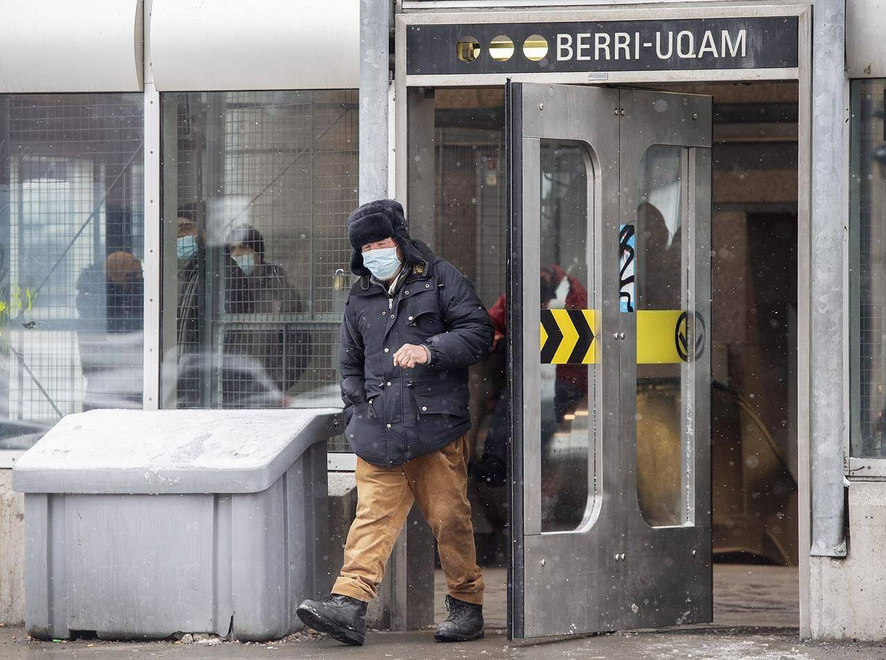 A man wears a face mask as he leaves a metro station in Montreal, Saturday, March 12, 2022, as the COVID-19 pandemic continues in Canada. Two public health experts say Quebec has already entered a sixth wave of the COVID-19 pandemic driven by the BA.2 subvariant. THE CANADIAN PRESS/Graham Hughes