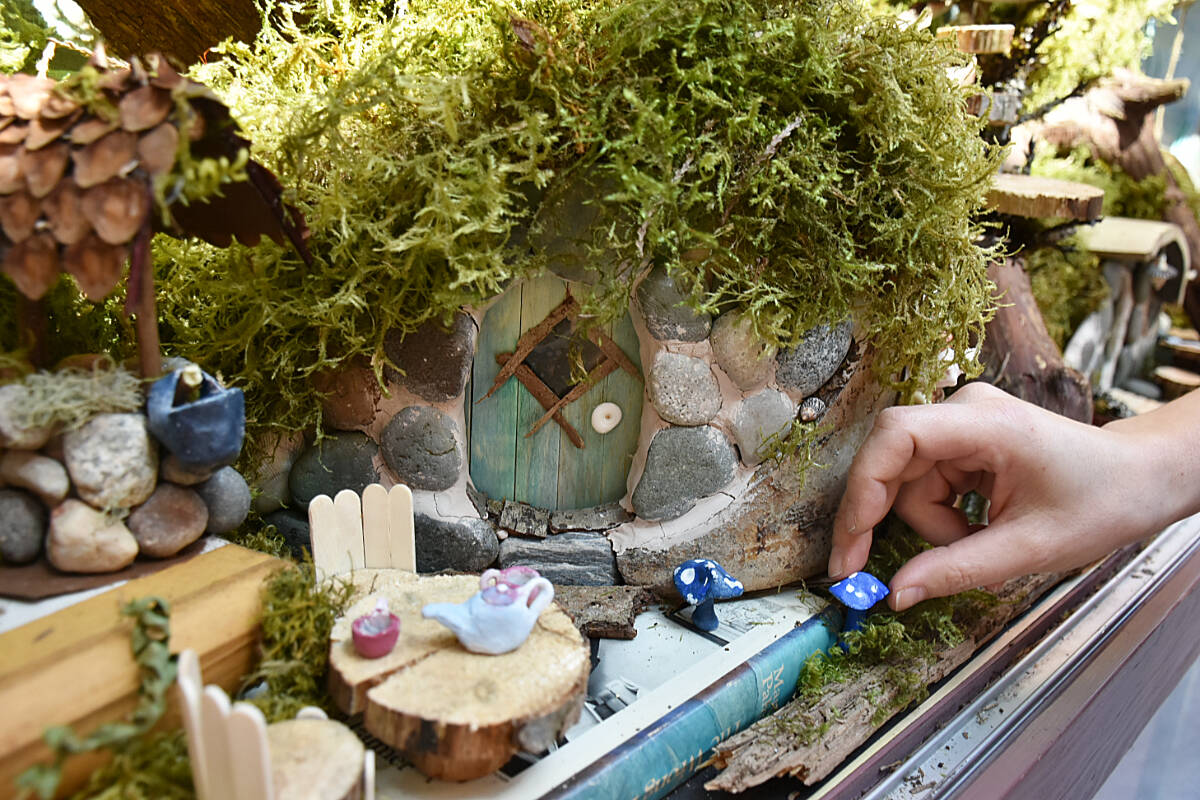 Paula Gross, an educational assistant at Eric Langton elementary, created a display of hobbit houses made primarily from discarded objects, for the front display case at the school. (Colleen Flanagan/The News)