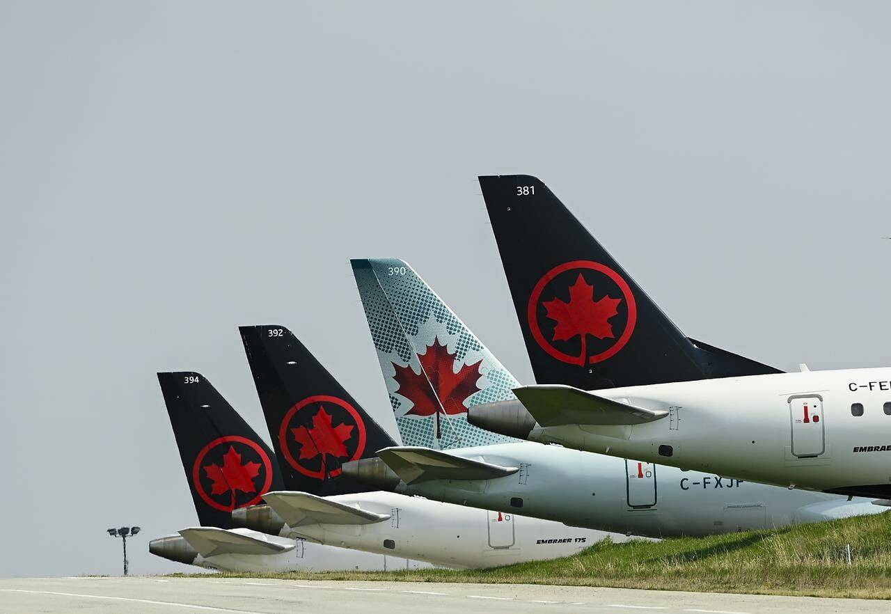 Grounded Air Canada planes sit on the tarmac at Pearson International Airport during the COVID-19 pandemic in Toronto on Wednesday, April 28, 2021. Air Canada reported a first-quarter loss of $974 million compared with a loss of $1.30 billion a year earlier as its revenue more than tripled. THE CANADIAN PRESS/Nathan Denette