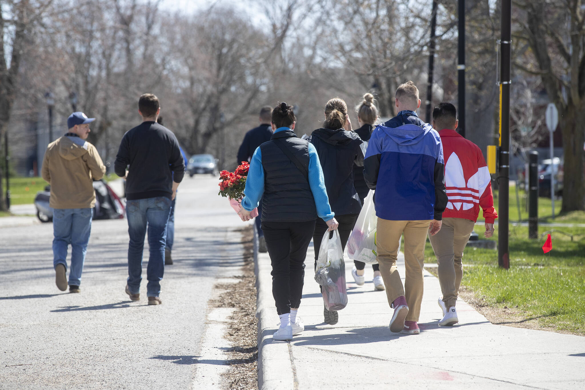 Cadets carry flowers at the Royal Military College in Kingston, Ontario on Friday April 29, 2022. The Department of National Defence says it’s investigating an incident involving a vehicle at the Royal Military College campus. THE CANADIAN PRESS/Lars Hagberg