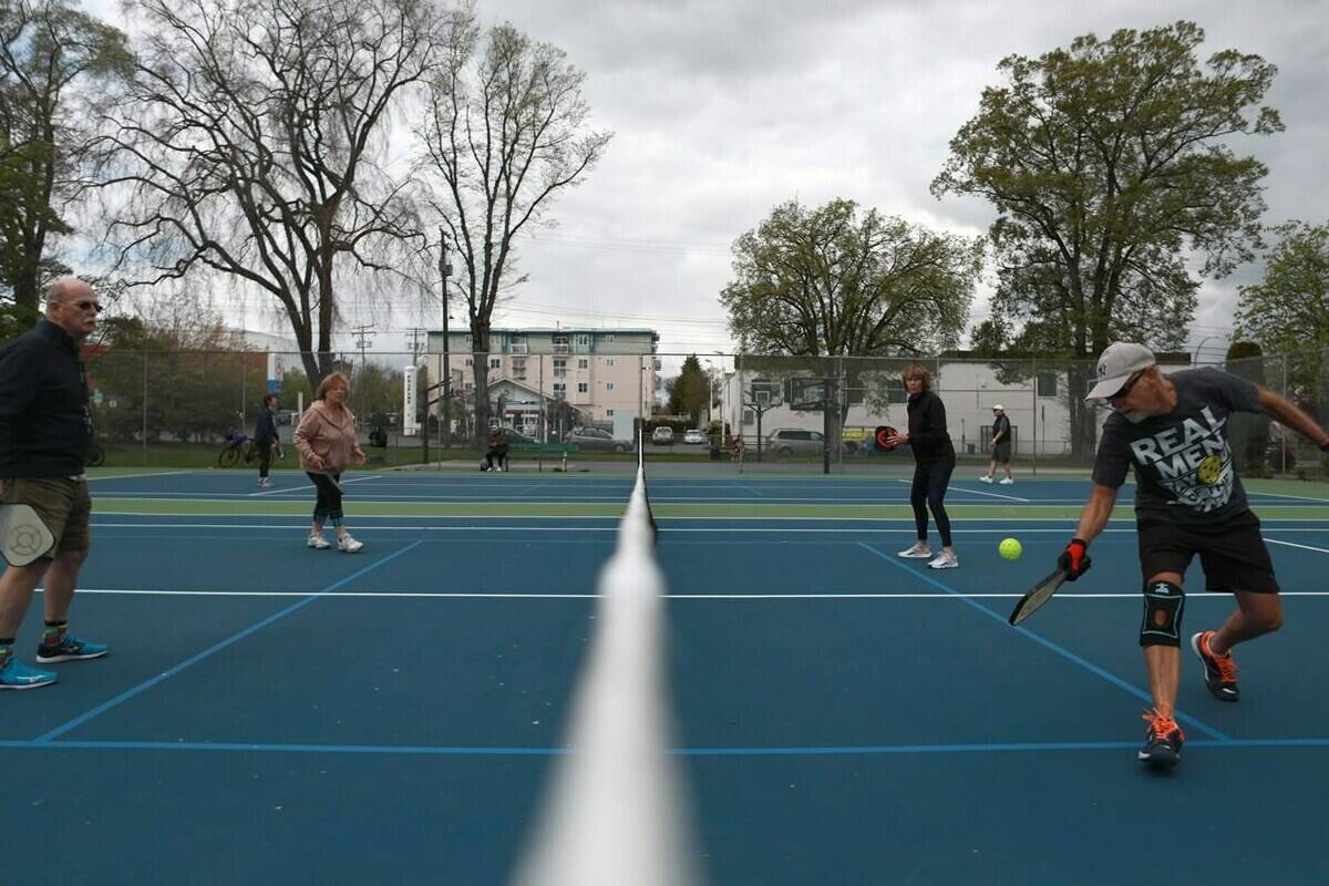 From left to right, Tony Gibb Joanne Rakers, Tania Brachmayer and Peter Brachmayer, play a game of pickleball at a court in the Central Park neighbourhood of Victoria, B.C., on Thursday, Apr. 28, 2022. THE CANADIAN PRESS/Chad Hipolito