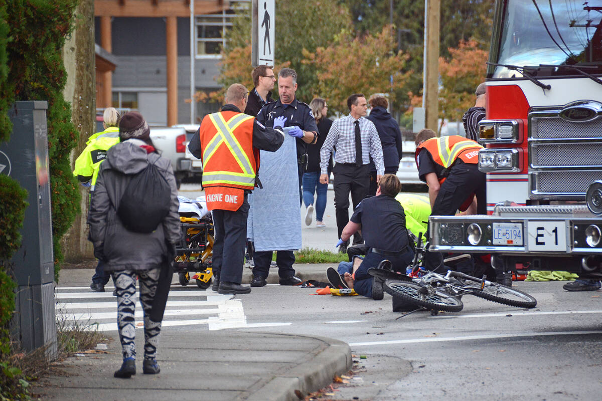 FILE: Chilliwack firefighters and paramedics tend to a teenager who was struck by a vehicle outside Chilliwack Secondary. (Paul Henderson/ The Progress)