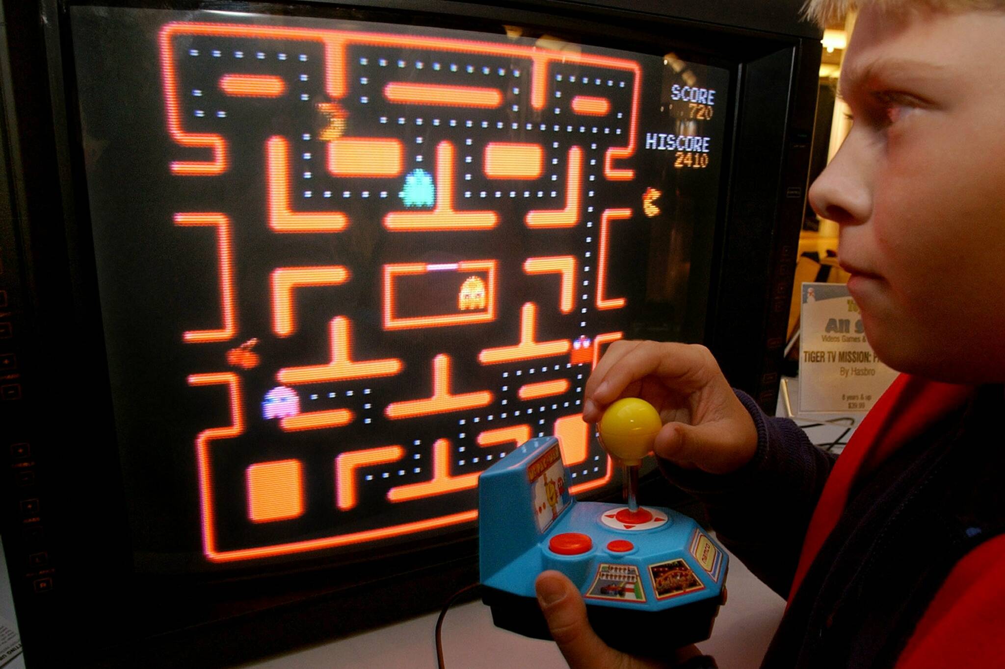 FILE - In this Oct. 5, 2004, file photo, Jake Gautney, 12, of Chappaqua, N.Y., tries a Ms. Pac-Man game at the Toy Industry Association holiday preview in New York. Masaya Nakamura, the “Father of Pac-Man” who founded the Japanese video game company behind the hit creature-gobbling game, died on Jan. 22, 2017. He was 91. (AP Photo/Richard Drew, File)