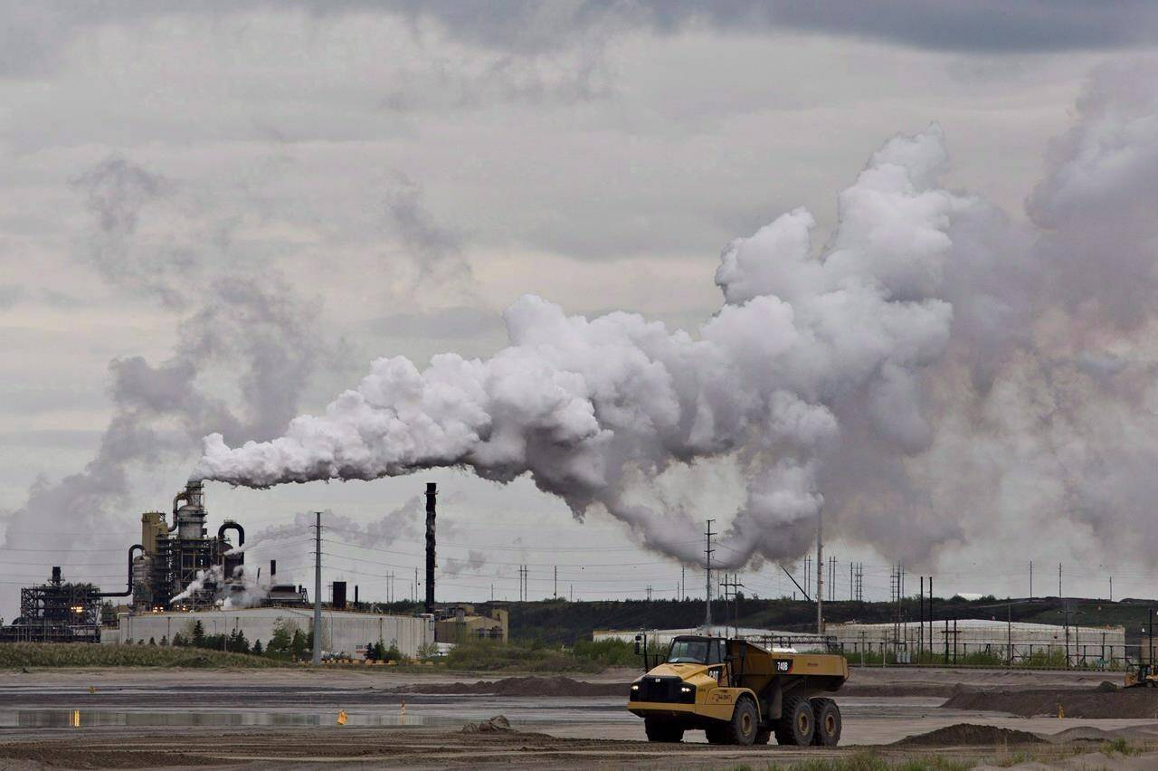 A dump truck works near the Syncrude oil sands extraction facility near the city of Fort McMurray, Alberta on June 1, 2014. Thirteen years after Canada first signed an international agreement to eliminate “inefficient” government subsidies to the fossil fuel sector, and four years since launching a peer review with Argentina to identify what subsidies exist, the federal government is still working to define what an inefficient fossil fuel subsidy actually is. THE CANADIAN PRESS/Jason Franson