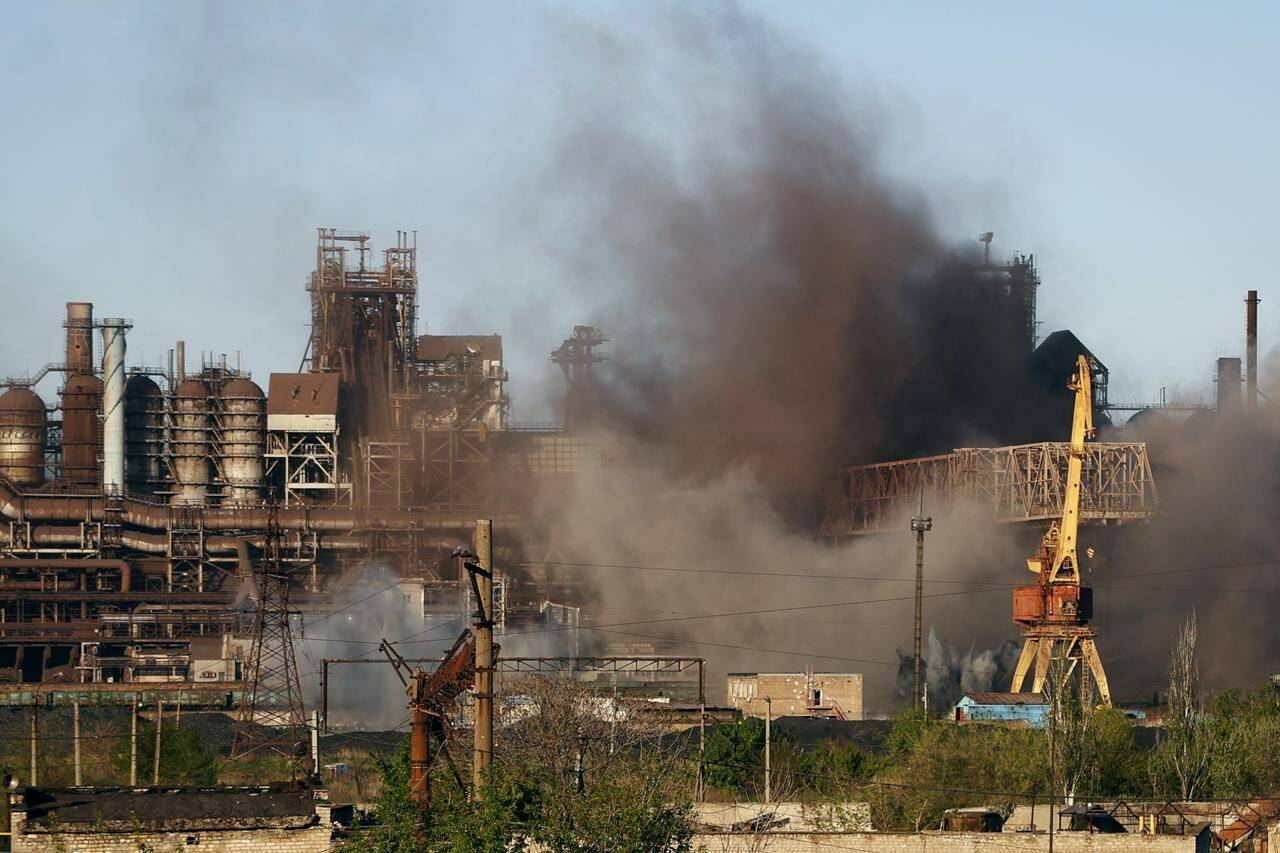 Smoke rises from the Metallurgical Combine Azovstal in Mariupol during shelling, in Mariupol, in territory under the government of the Donetsk People’s Republic, eastern Ukraine, Saturday, May 7, 2022. (AP Photo/Alexei Alexandrov)