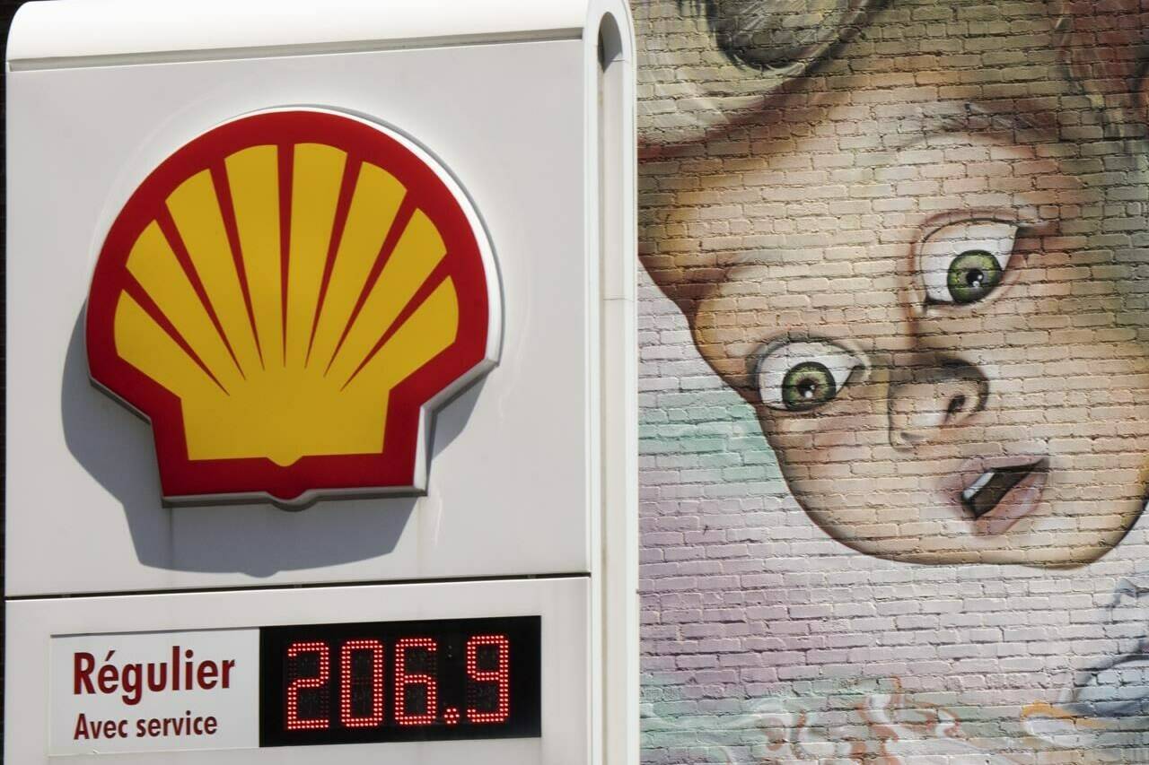 A gas station sign is seen in front of a wall mural as gas prices surpass $2.00 per litre, Monday, May 9, 2022 in Montreal.THE CANADIAN PRESS/Ryan Remiorz