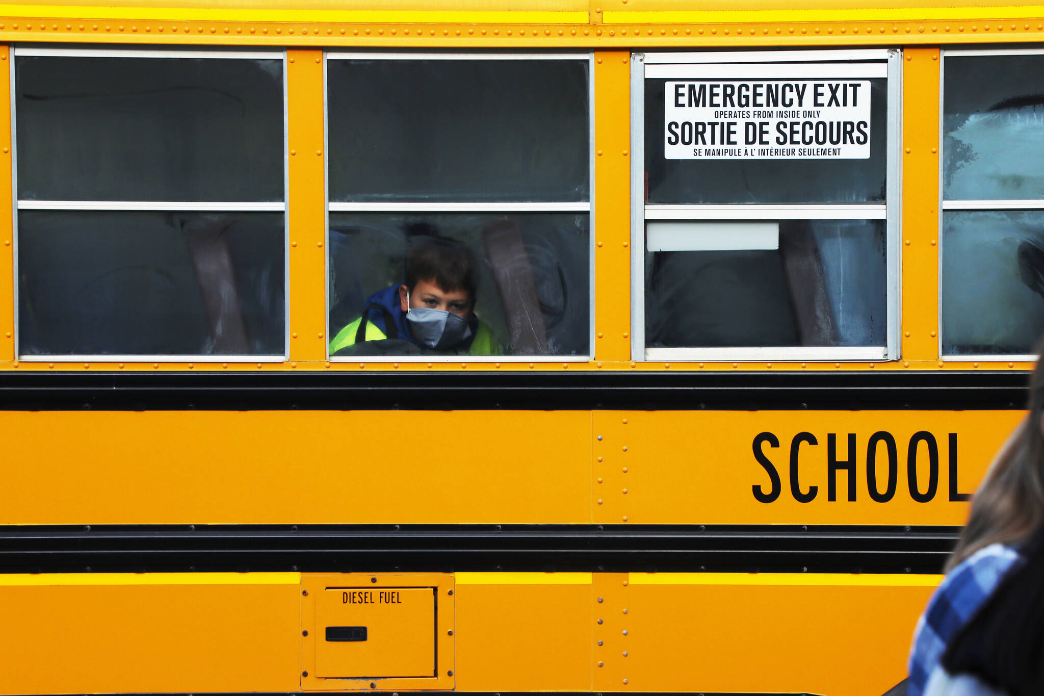 A W.L. McLeod student wearing a mask in a school bus. (Aman Parhar/Omineca Express)