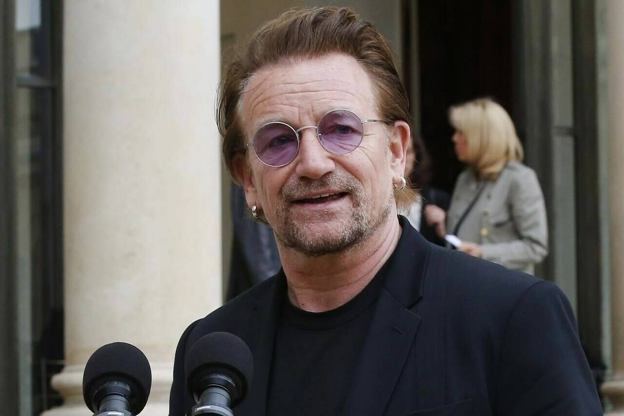 FILE - U2 singer Bono speaks to the media after a meeting at the Elysee Palace, in Paris, France on July 24, 2017. Bono’s memoir “Surrender” planned for release on Nov. 1. (AP Photo/Michel Euler, File)