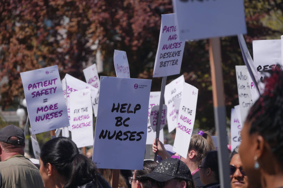 Protesters hold signs during a rally Tuesday at the legislature for the BC Nurses’ Union during National Nursing Week. (Evert Lindquist/News Staff)