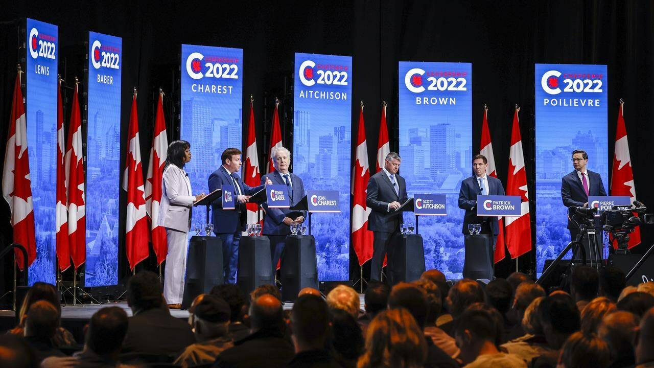 Candidates, left to right, Leslyn Lewis, Roman Baber, Jean Charest, Scott Aitchison, Patrick Brown, and Pierre Poilievre at the Conservative Party of Canada English leadership debate in Edmonton, Alta., Wednesday, May 11, 2022.THE CANADIAN PRESS/Jeff McIntosh