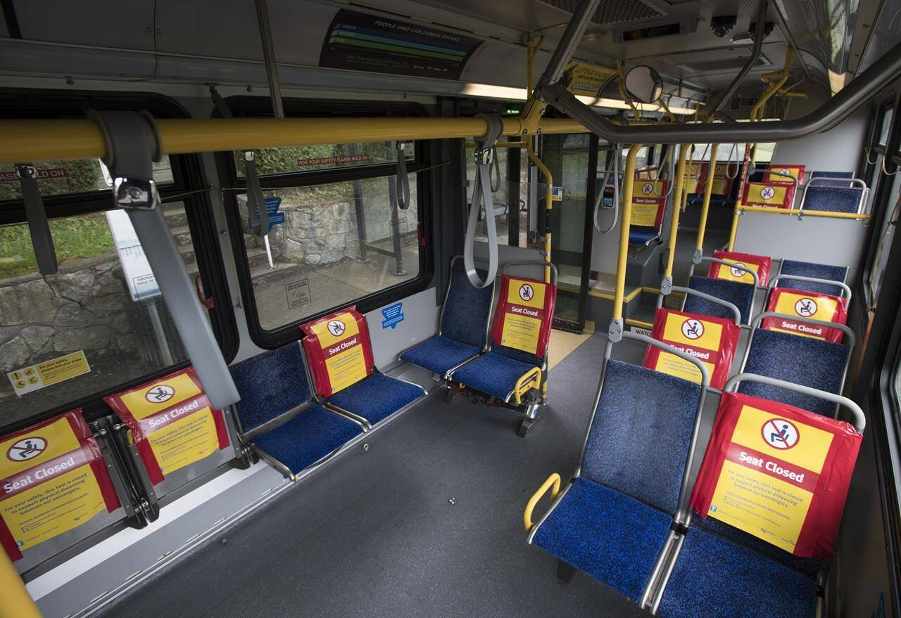Signs indicating seats which are closed to promote physical distancing during the COVID-19 pandemic are pictured on a public transit bus in North Vancouver, B.C., Tuesday, May 12, 2020. THE CANADIAN PRESS/Jonathan Hayward