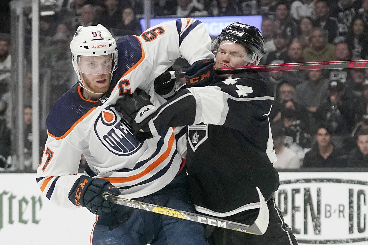 Edmonton Oilers centre Connor McDavid, left, and Los Angeles Kings defenceman Mikey Anderson battle during the first period in Game 6 of an NHL hockey Stanley Cup first-round playoff series Thursday, May 12, 2022, in Los Angeles. (AP Photo/Mark J. Terrill)