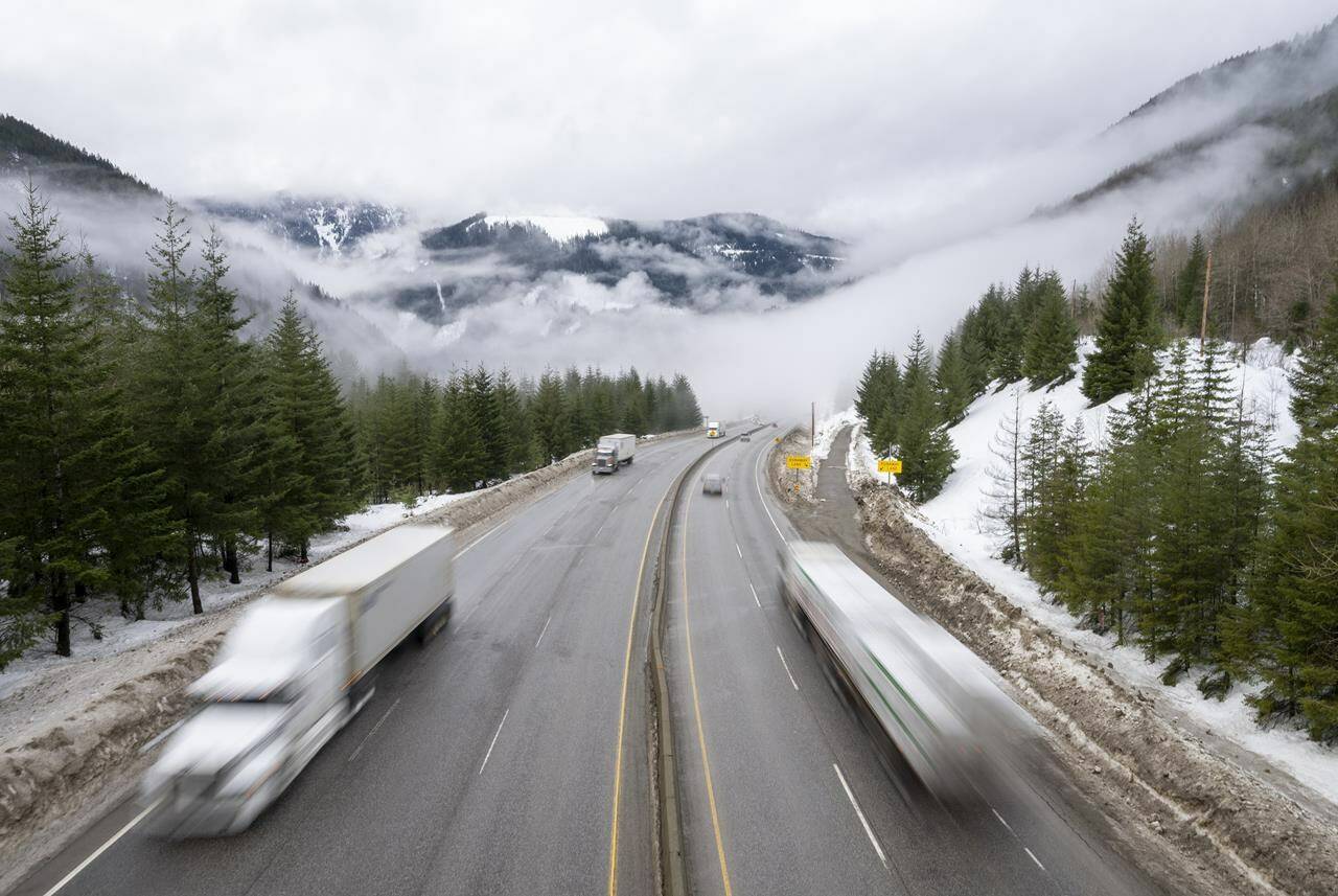Vehicles are seen as they drive along the Coquihalla Highway Wednesday, Jan. 19, 2022. Highways through southern British Columbia’s mountain passes looked more like mid-winter than mid-May early Friday as Environment Canada advised another five more centimetres of snow was expected before the latest unseasonable weather eased. THE CANADIAN PRESS/Jonathan Hayward