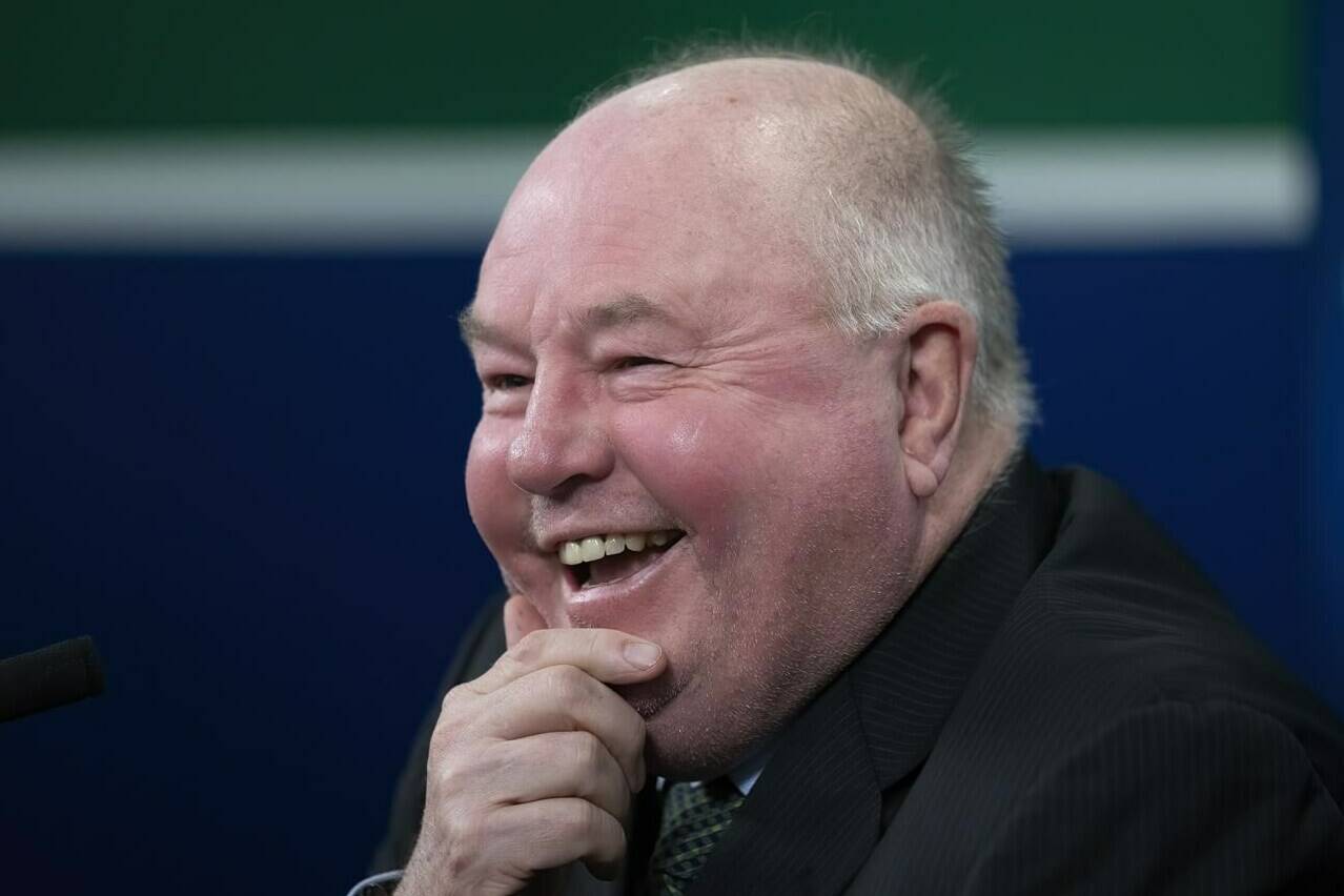 Vancouver Canucks head coach Bruce Boudreau smiles as he attends a news conference in Vancouver, on Dec. 6, 2021. Boudreau will return as the Canucks head coach next season after helping to turn the struggling NHL club around as a mid-season replacement. THE CANADIAN PRESS/Jonathan Hayward