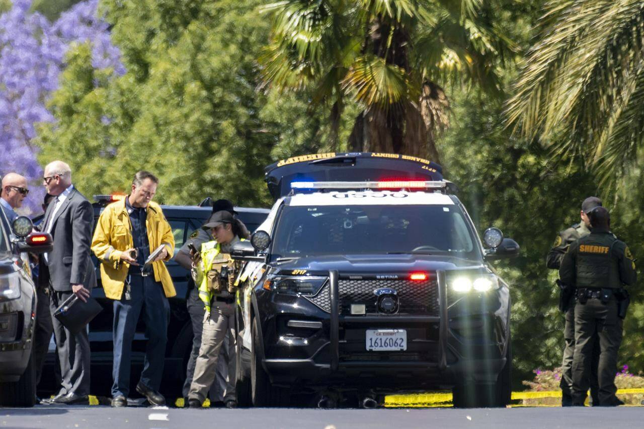 Investigators gather outside the Geneva Presbyterian Church in Laguna Woods, Calif., on Sunday, May 15, 2022 after a fatal shooting. (Leonard Ortiz/The Orange County Register via AP)