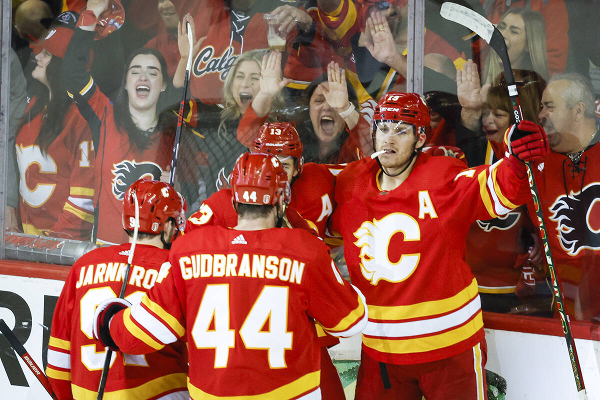 Calgary Flames forward Matthew Tkachuk, right, celebrates his goal with teammates during second period NHL playoff hockey action against the Dallas Stars in Calgary, Alta., Sunday, May 15, 2022. THE CANADIAN PRESS/Jeff McIntosh