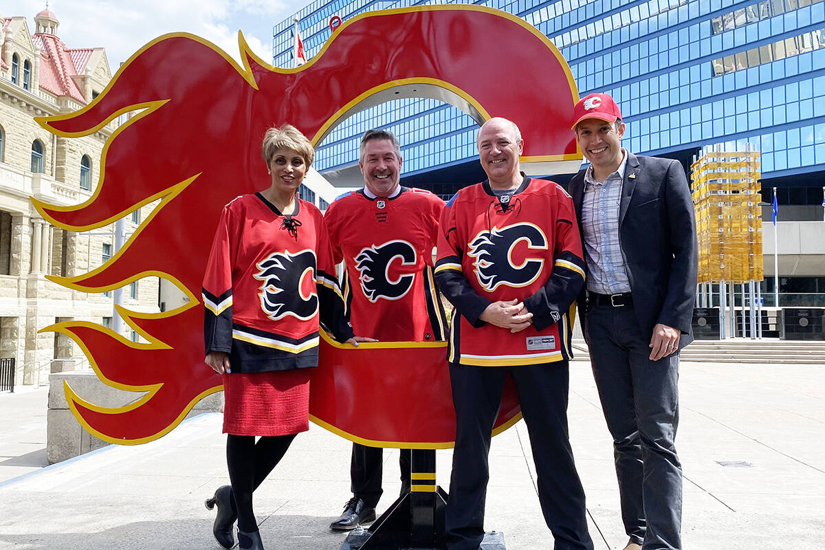 Calgary Mayor Jyoti Gondek, Coun. Dan McLean, Coun. Peter Demong and Coun. Evan Spencer (left to right) pose at Calgary City Hall on Monday, May 16, 2022. Gondek announced a friendly wager between the Calgary and Edmonton city councils for the upcoming Battle of Alberta NHL series between the Calgary Flames and the Edmonton Oilers. THE CANADIAN PRESS/Colette Derworiz