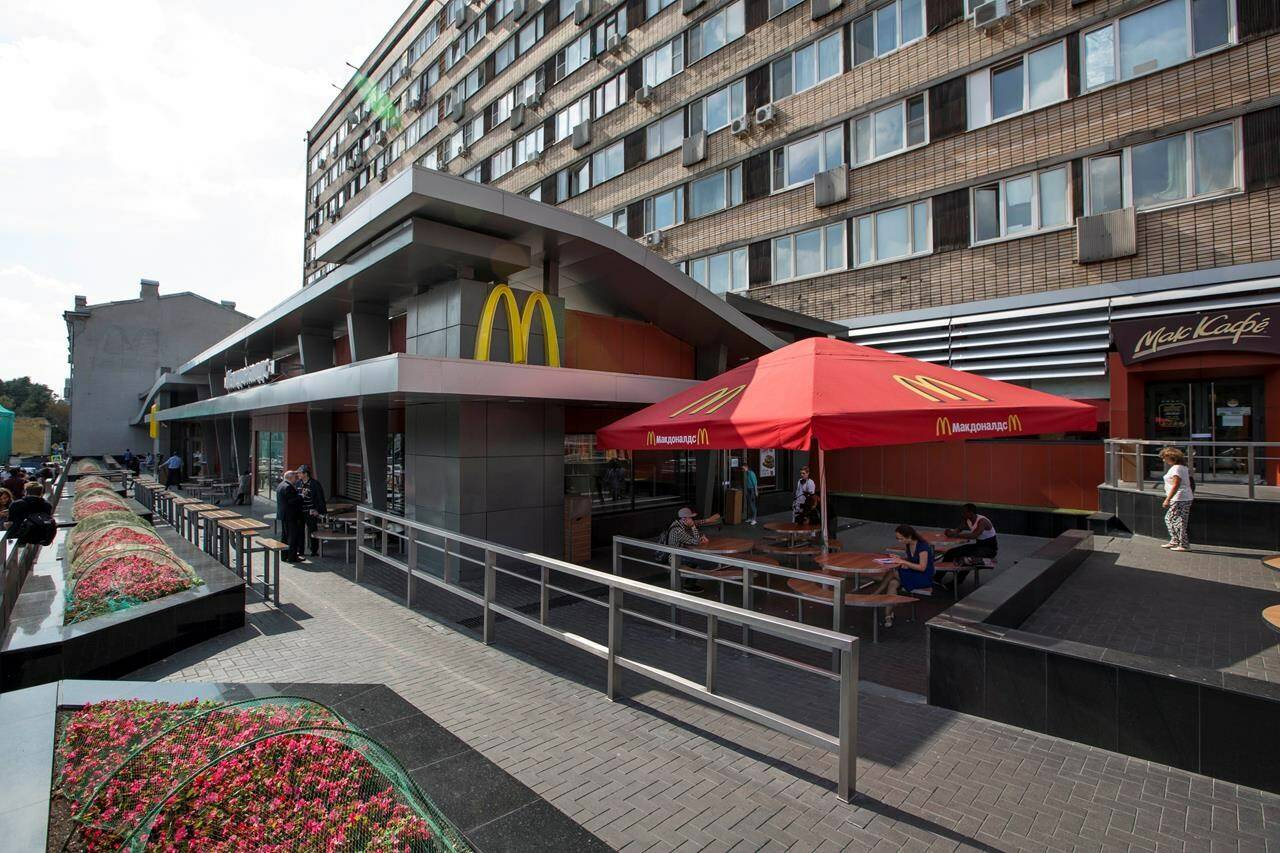 FILE - The oldest of Moscow’s McDonald’s outlets, which was opened on Jan. 31, 1990, is closed on Aug. 21, 2014. McDonald’s says it’s started the process of selling its Russian business, which includes 850 restaurants that employ 62,000 people. The fast food giant pointed to the humanitarian crisis caused by the war, saying holding on to its business in Russia “is no longer tenable, nor is it consistent with McDonald’s values.” The Chicago-based company had temporarily closed its stores in Russia but was still paying employees. (AP Photo/FILE)