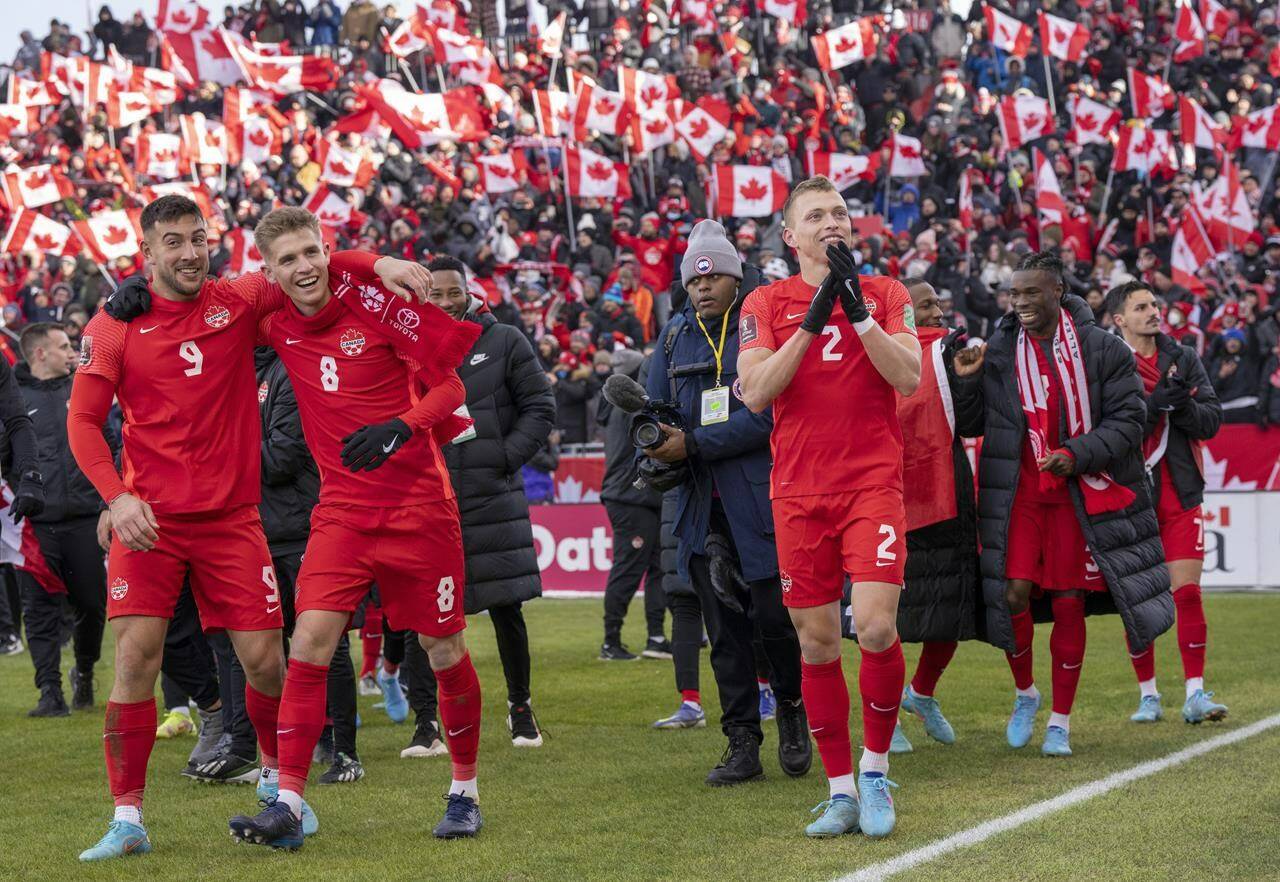 Members of Canada’s national soccer team celebrate after clinching a berth in CONCACAF World Cup Qualifier soccer action against Jamaica in Toronto on Sunday March 27, 2022 THE CANADIAN PRESS/Frank Gunn