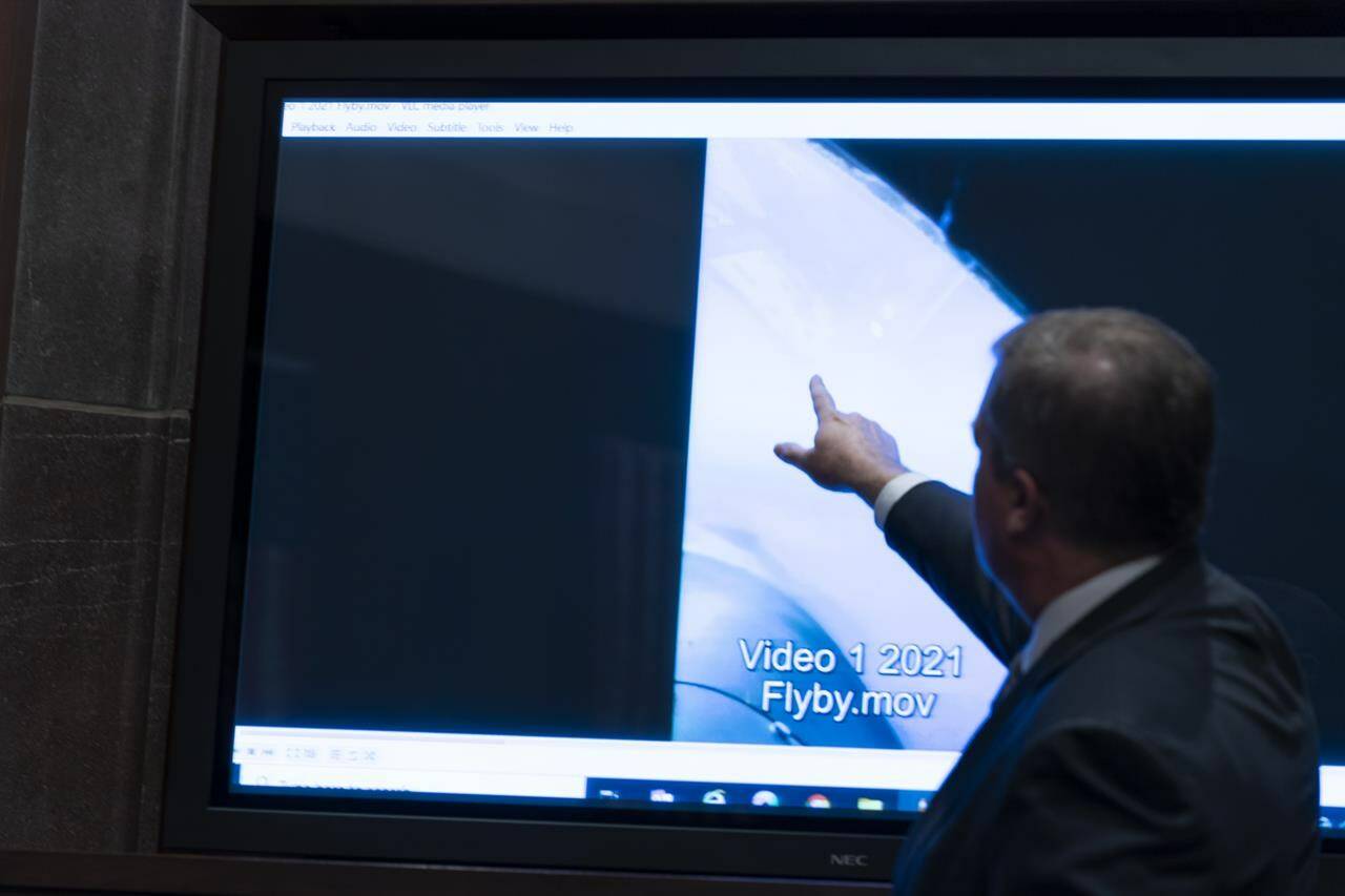 Deputy Director of Naval Intelligence Scott Bray points to a video display of a UAP during a hearing of the House Intelligence, Counterterrorism, Counterintelligence, and Counterproliferation Subcommittee hearing on “Unidentified Aerial Phenomena,” on Capitol Hill, Tuesday, May 17, 2022, in Washington. (AP Photo/Alex Brandon)