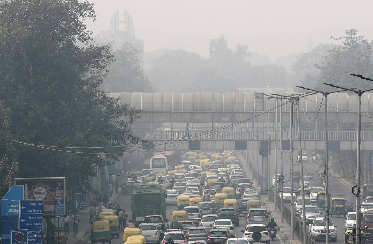 A pedestrian walks on a bridge above vehicle traffic in New Delhi, India, Tuesday, Nov. 12, 2019, as the city is enveloped under thick smog. The air quality index exceeded 400, about eight times the recommended maximum. A study released on Tuesday, May 17, 2022, blames pollution of all types for 9 million deaths a year globally, with the death toll attributed to dirty air from cars, trucks and industry rising 55% since 2000. (AP Photo/Manish Swarup, File)