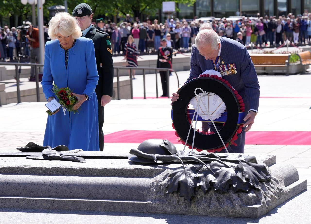 Prince Charles places a wreath as he and Camilla, Duchess of Cornwall, visit the National War Memorial in Ottawa, while on their Canadian Royal Tour, Wednesday May 18, 2022. THE CANADIAN PRESS/Paul Chiasson