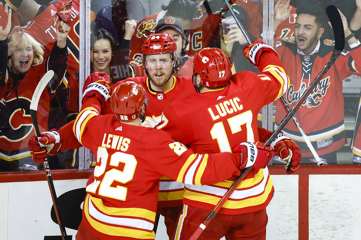 Calgary Flames forward Brett Ritchie, centre, celebrates his goal with teammates centre Trevor Lewis (22) and left wing Milan Lucic (17) during first period NHL second round playoff hockey action against the Calgary Flames in Calgary, Wednesday, May 18, 2022.THE CANADIAN PRESS/Jeff McIntosh