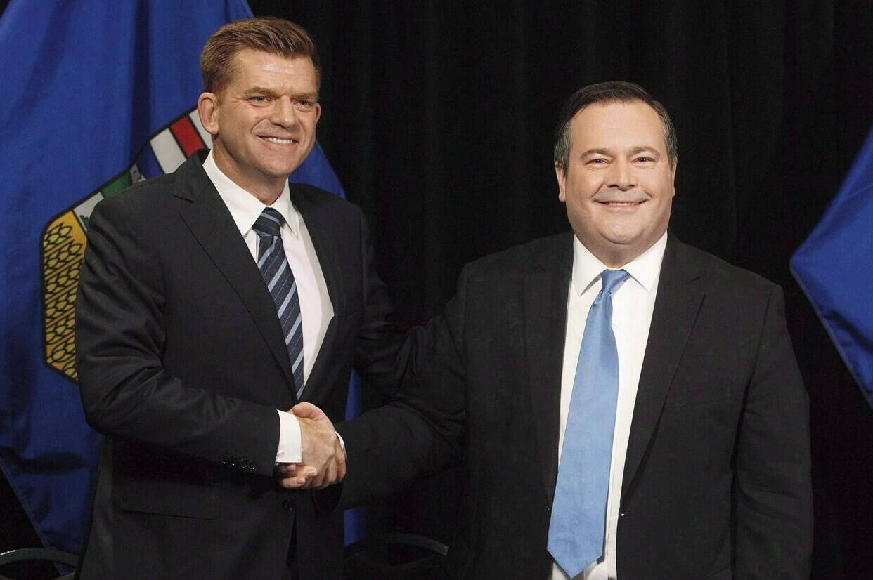 Alberta Wildrose leader Brian Jean and Alberta PC leader Jason Kenney shake hands after announcing a unity deal between the two parties in Edmonton on May 18, 2017. THE CANADIAN PRESS/Jason Franson