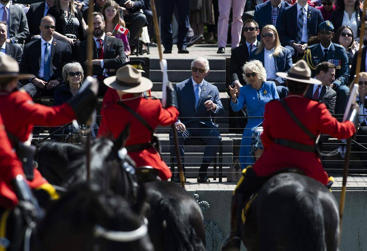 Prince Charles and Camilla, Duchess of Cornwall watch a performance of the RCMP Musical Ride in Ottawa, during their Canadian Royal tour, on Wednesday, May 18, 2022. THE CANADIAN PRESS/Justin Tang