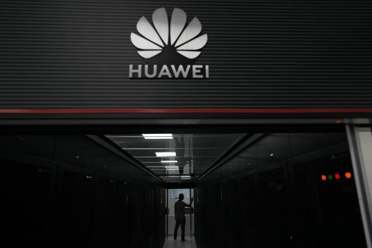 A technician stands at the entrance to a Huawei 5G data server centre at the Guangdong Second Provincial General Hospital in Guangzhou, in southern China’s Guangdong province on Sept. 26, 2021. Senior government officials say the Liberals have decided to ban Chinese the vendor Huawei Technologies from Canada’s long-awaited blueprint for next-generation mobile networks. THE CANADIAN PRESS/AP-Ng Han Guan