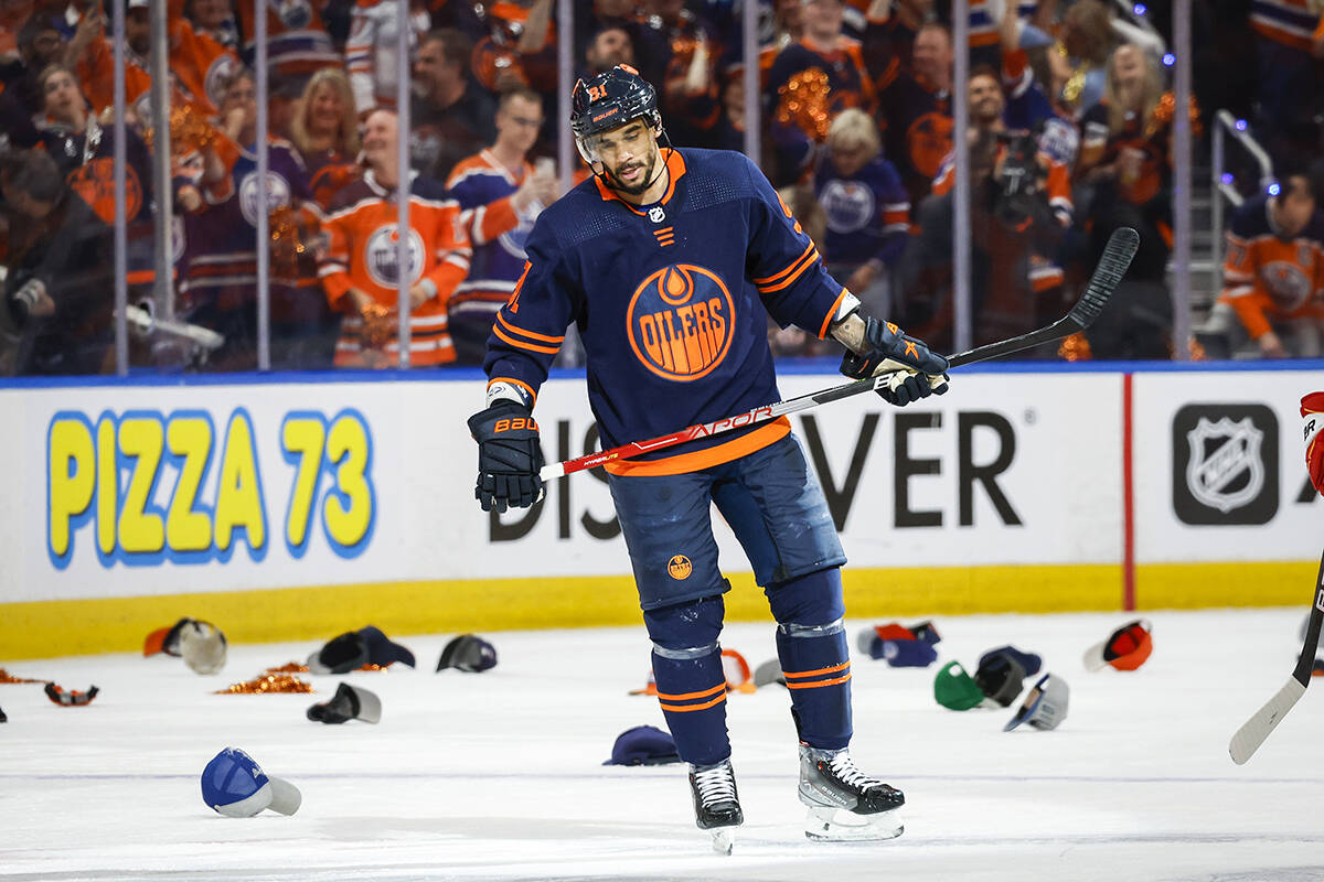 Edmonton Oilers winger Evander Kane skates amongst hats thrown onto the ice after his hat-trick during second period NHL second round playoff hockey action against the Calgary Flames in Edmonton, Sunday, May 22, 2022. THE CANADIAN PRESS/Jeff McIntosh