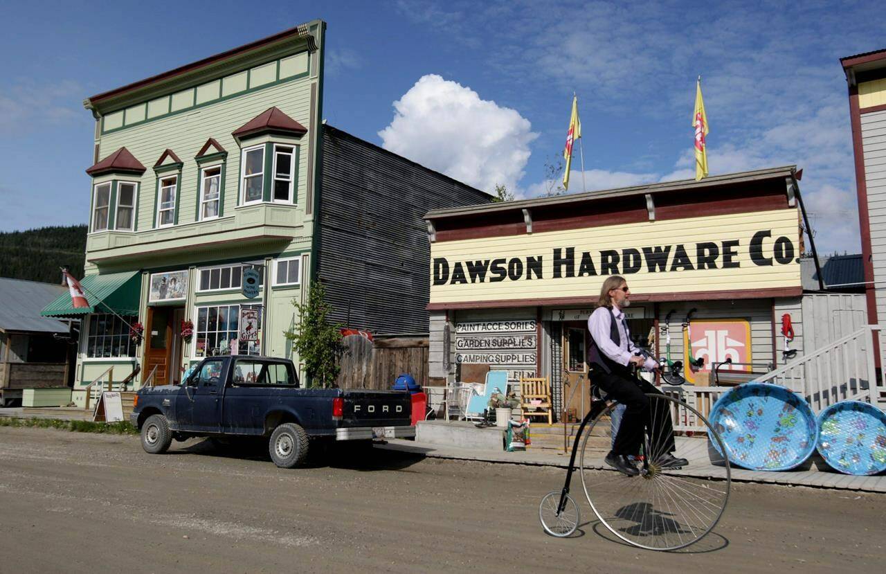 Eldo Enns rides his penny farthing bicycle in Dawson City, Yukon, on Friday June 19, 2009. Yukon’s tourism industry is abuzz with anticipation as Canada’s northernmost border opens June 1 for the first time since the pandemic began, says the executive director of the Klondike Visitors Association in Dawson City.THE CANADIAN PRESS/Darryl Dyck