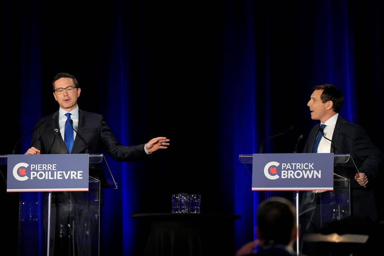Conservative leadership hopefuls Pierre Poilievre, left, and Patrick Brown share an exchange during the Conservative Party of Canada French-language leadership debate in Laval, Quebec on Wednesday, May 25, 2022. THE CANADIAN PRESS/Ryan Remiorz