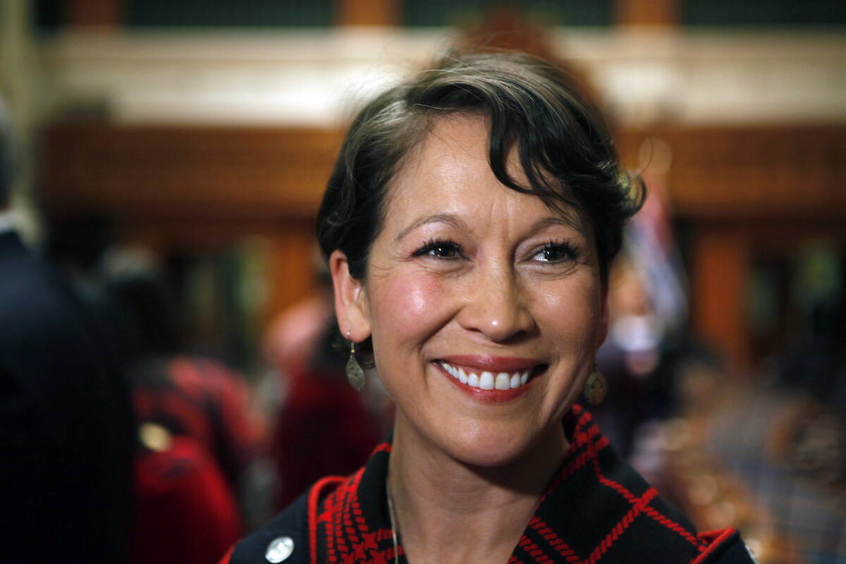 Melanie Mark, MLA elect for Vancouver-Mt Pleasant, speaks with media after becoming the first First Nations woman to serve in the legislature as she looks up at family and friends during a swearing in ceremony at legislature on Wednesday, February 17, 2016. THE CANADIAN PRESS/Chad Hipolito